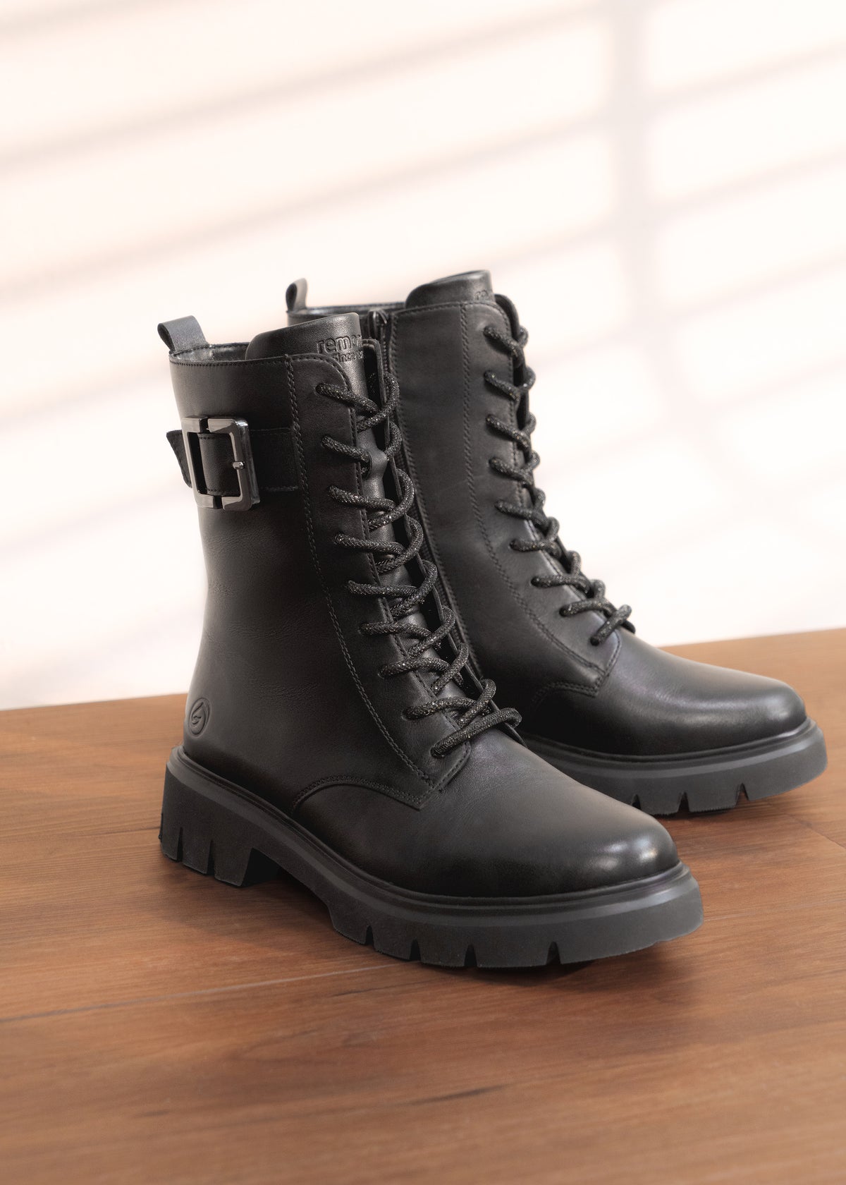 Ankle boots - black leather, buckle decoration on the shaft, sparkling laces